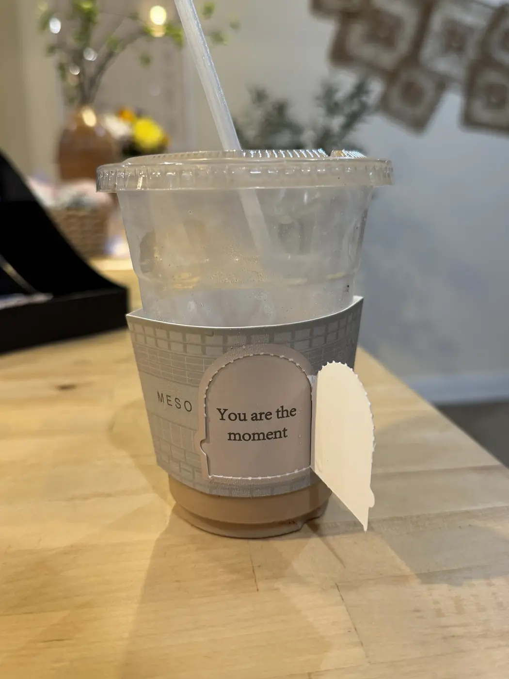 An iced signature latte in a Meso Cafe sleeve