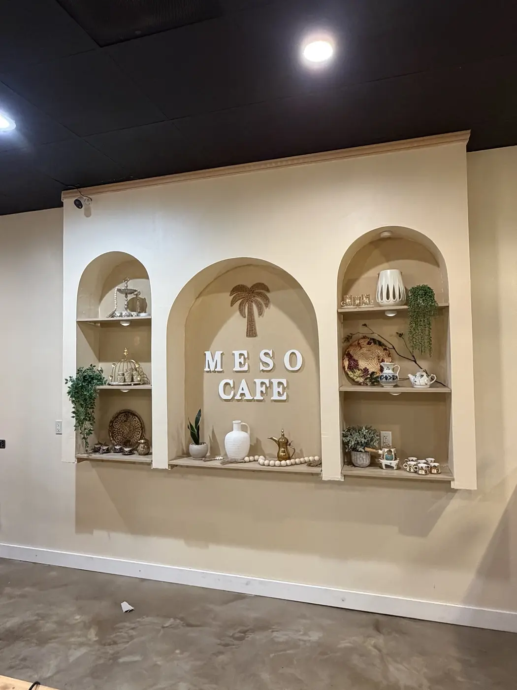 Tea glasses and decor on the arched shelving at Meso Cafe