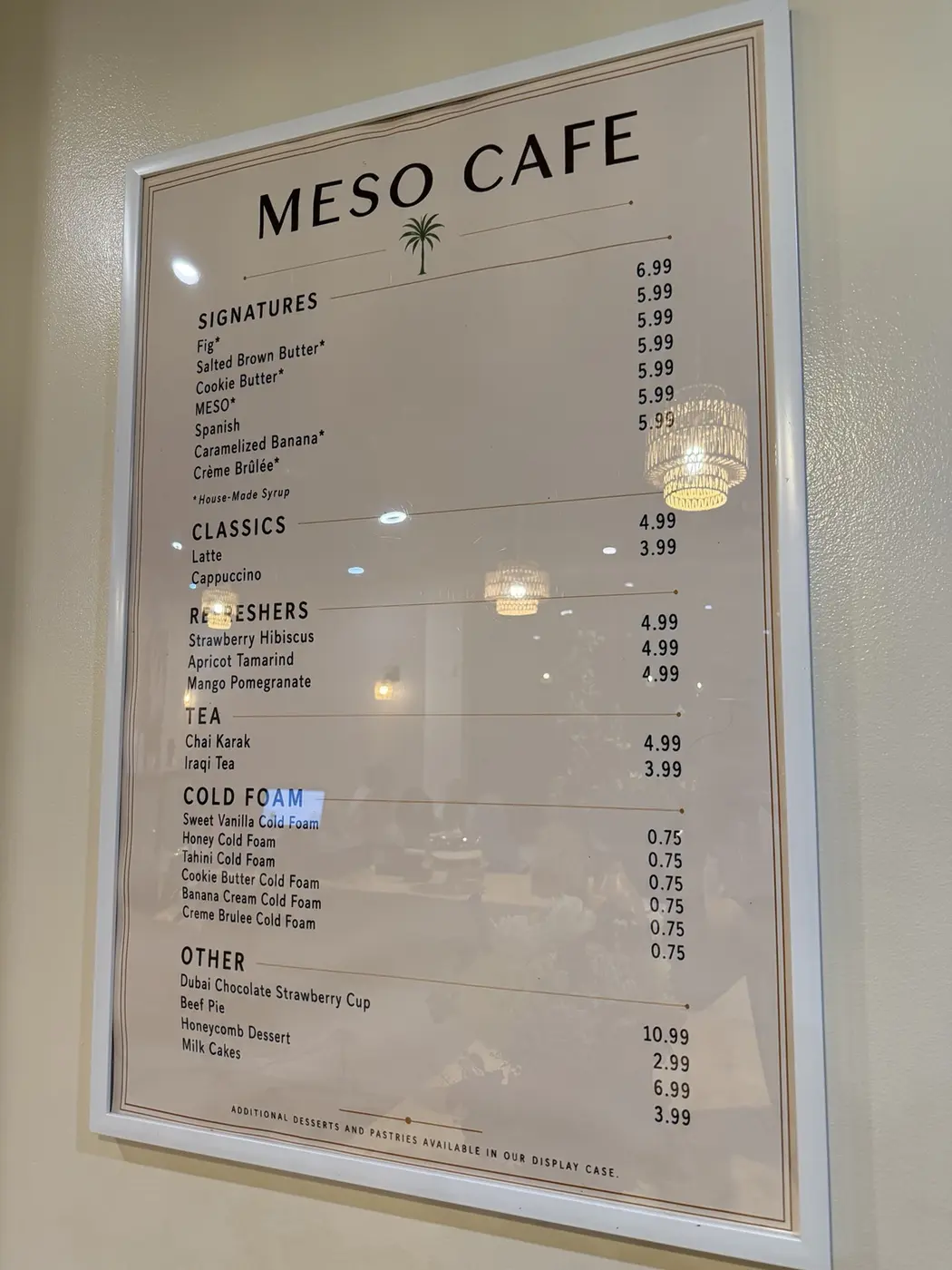 The printed menu board hanging behind the counter at Meso Cafe