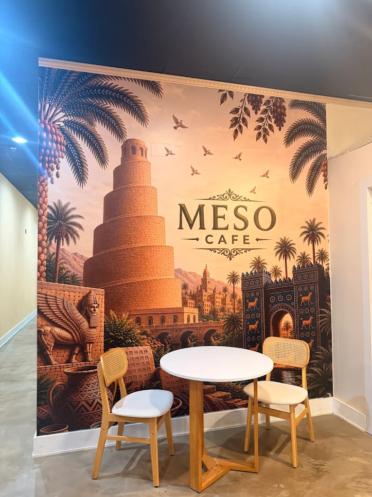 A table for two in front of the Mesopotamia mural